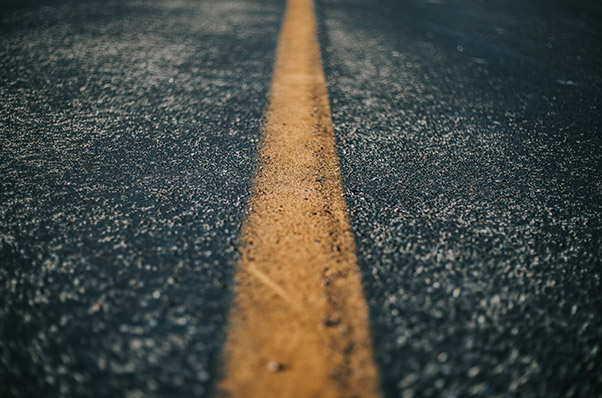 closeup of the yellow line in the middle of the road